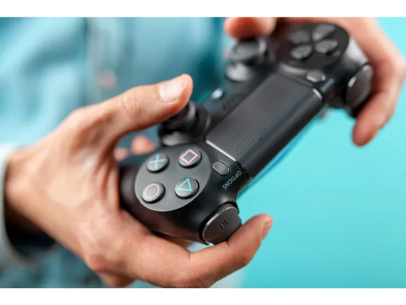 144635646_m man holding ps4 controller (1)