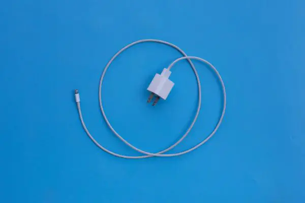 35481800 Mobile phone charger on blue background