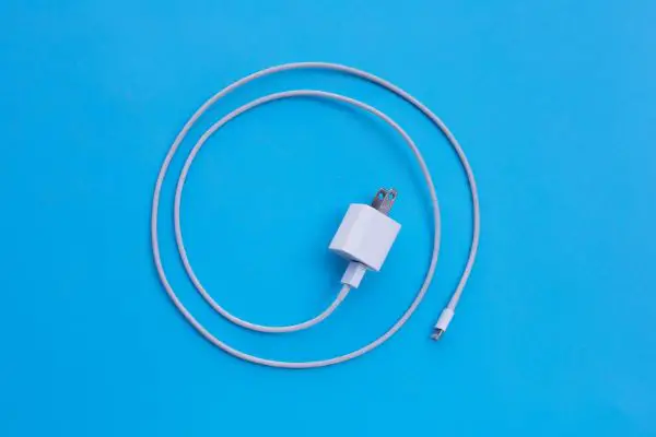 35481802 Mobile phone charger on blue background