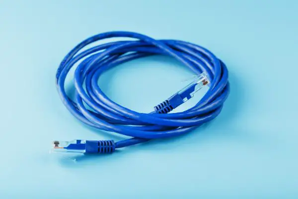 46156000 Blue Ethernet Cable Cord Patch cord on a blue background with free space
