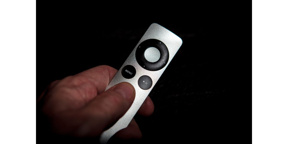 AdobeStock_126002249 Using the Remote Control apple tv on black background