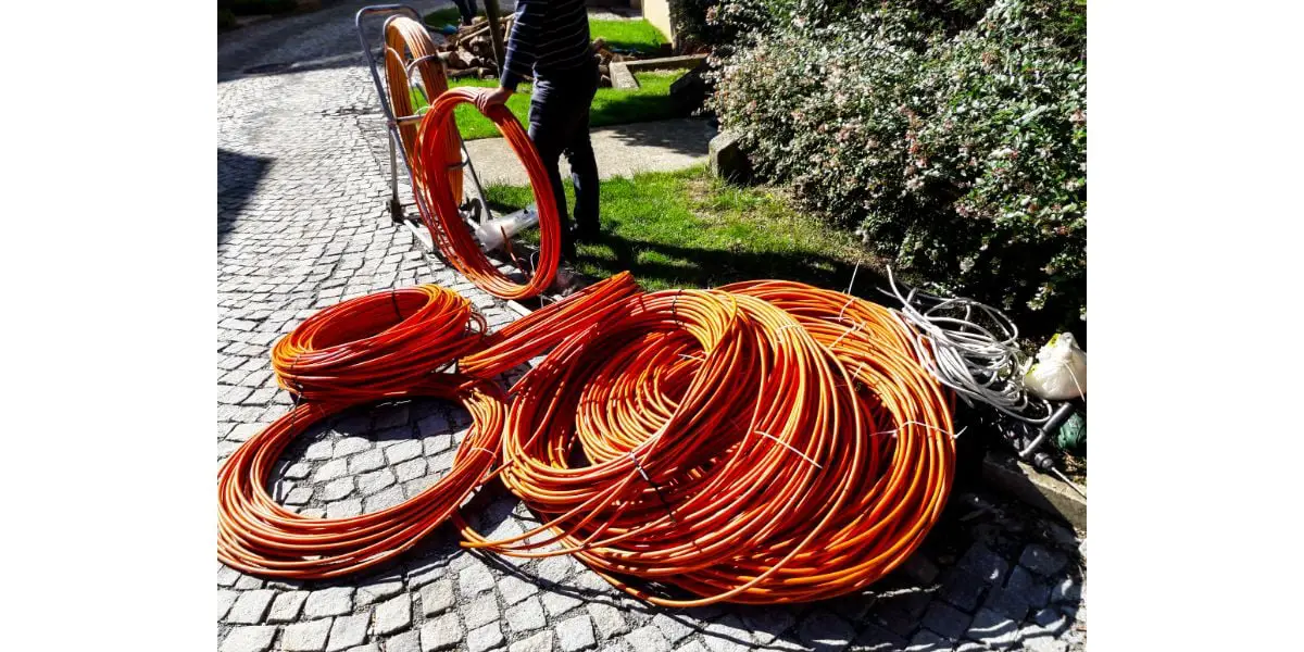AdobeStock_175640290 Orange fibre or fiber optic cables at garden for excavation
