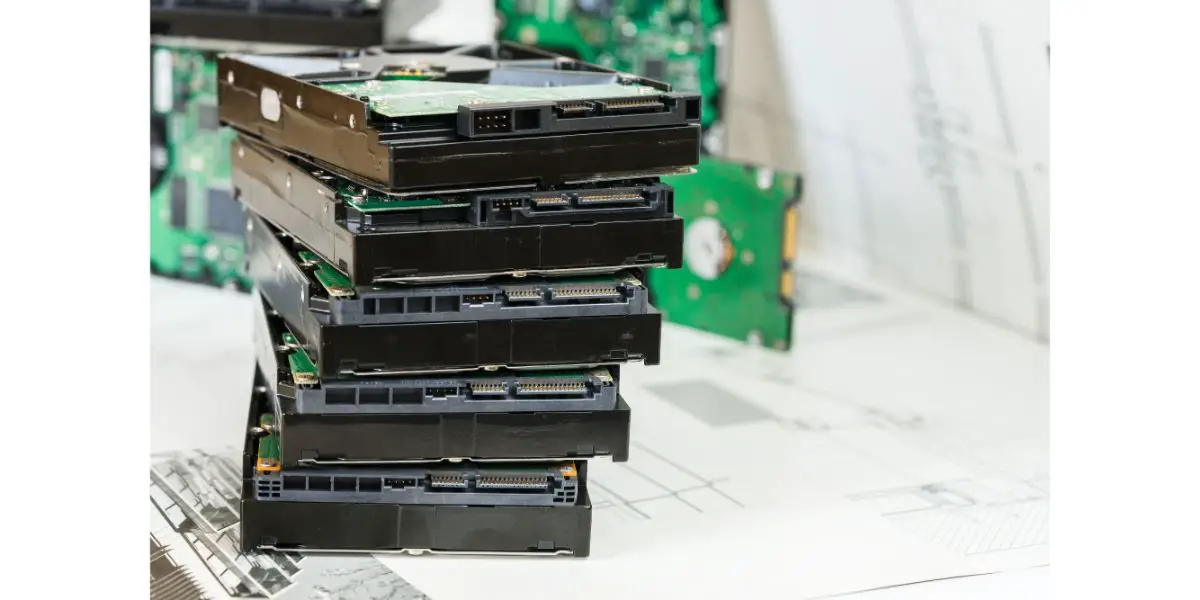 AdobeStock_188605828 pile of hard drives at white background