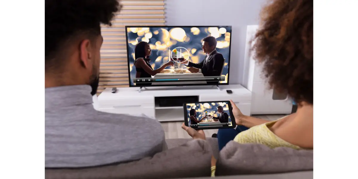 AdobeStock_190667118 Couple Connecting Television Through WiFi On Digital Tablet in living room