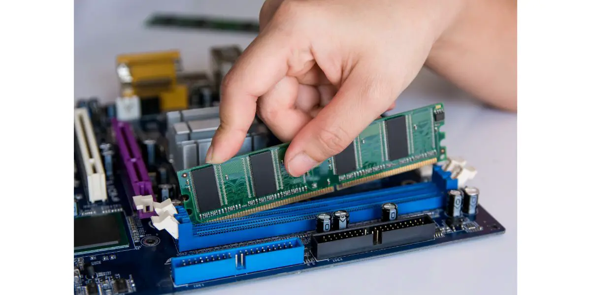 AdobeStock_207976302 Technician installing RAM stick (random access memory) to socket on motherboard