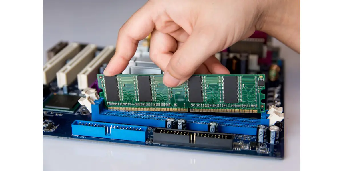 AdobeStock_207976327 Technician installing RAM stick (random access memory) to socket on motherboard