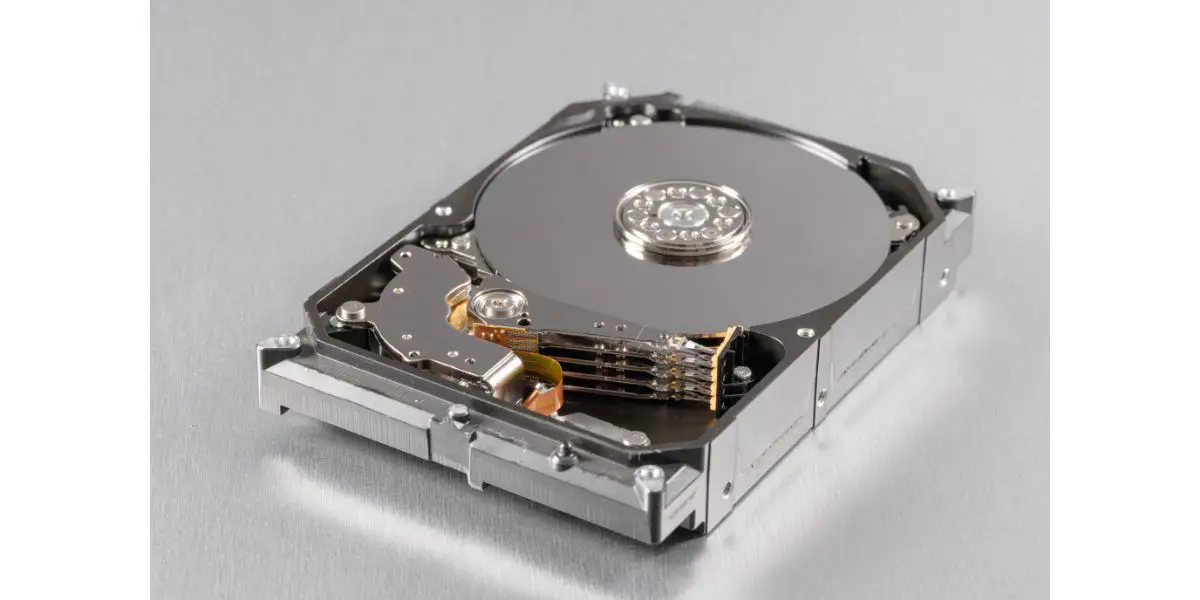 AdobeStock_208796886 Computer hard disk drive opened up white background