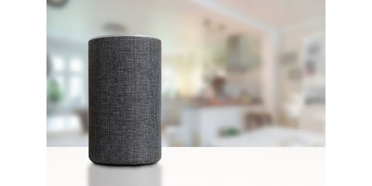 AdobeStock_229815426 Personal assistant loudspeaker on a white wooden shelf of a smart home kitchen