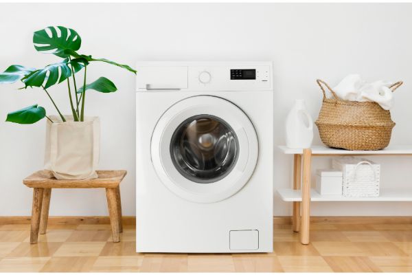 AdobeStock_270753549 Clothes washing machine in laundry room interior