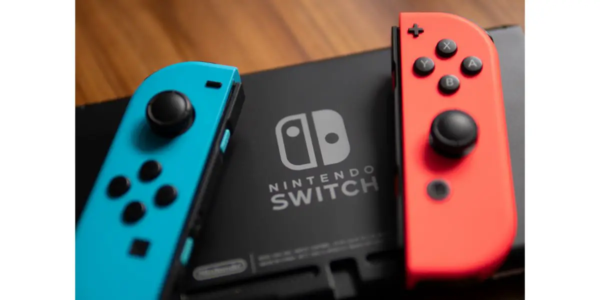 AdobeStock_285740608_Editorial_Use_Only Nintendo Switch controller, was placed beside the Nintendo Switch Logo