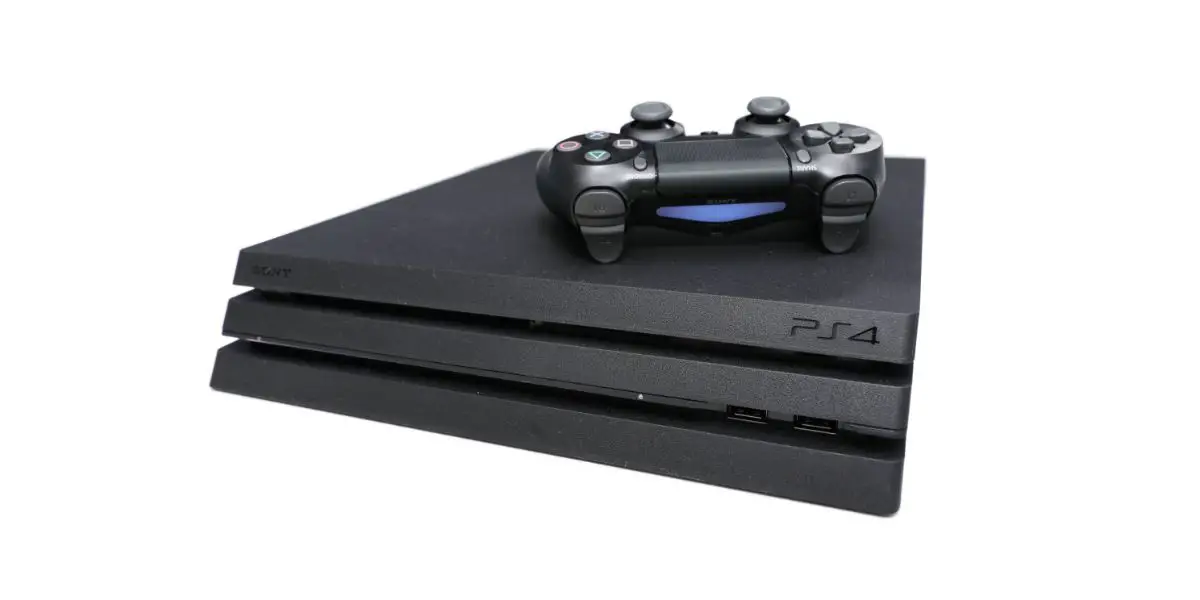 AdobeStock_294112346_Editorial_Use_Only New Sony Dualshock Controller on top of PlayStation 4 Pro with white background