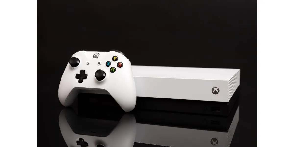 AdobeStock_296074825_Editorial_Use_Only white xbox one with white controller on black background