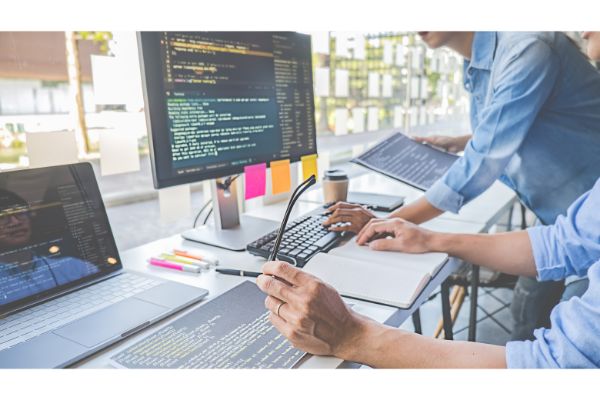 AdobeStock_311597945 Programmer working in a software development and coding technologies. Website design. Technology concept.