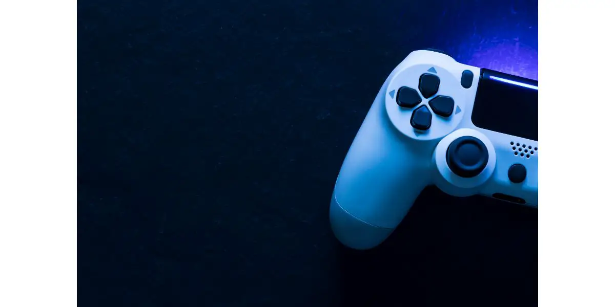 AdobeStock_314250039 Video game gaming controller night with lights dark background top view