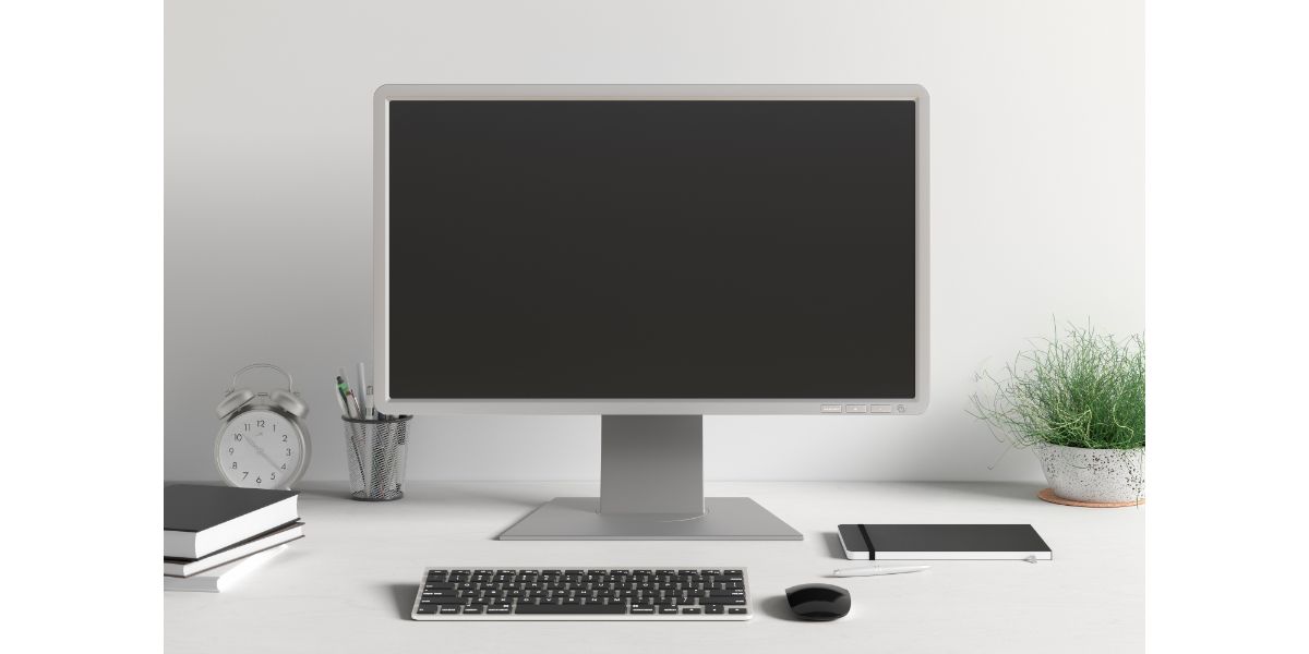 AdobeStock_320377304 Workspace with blank computer monitor black screen mock up on the white desk near white wall