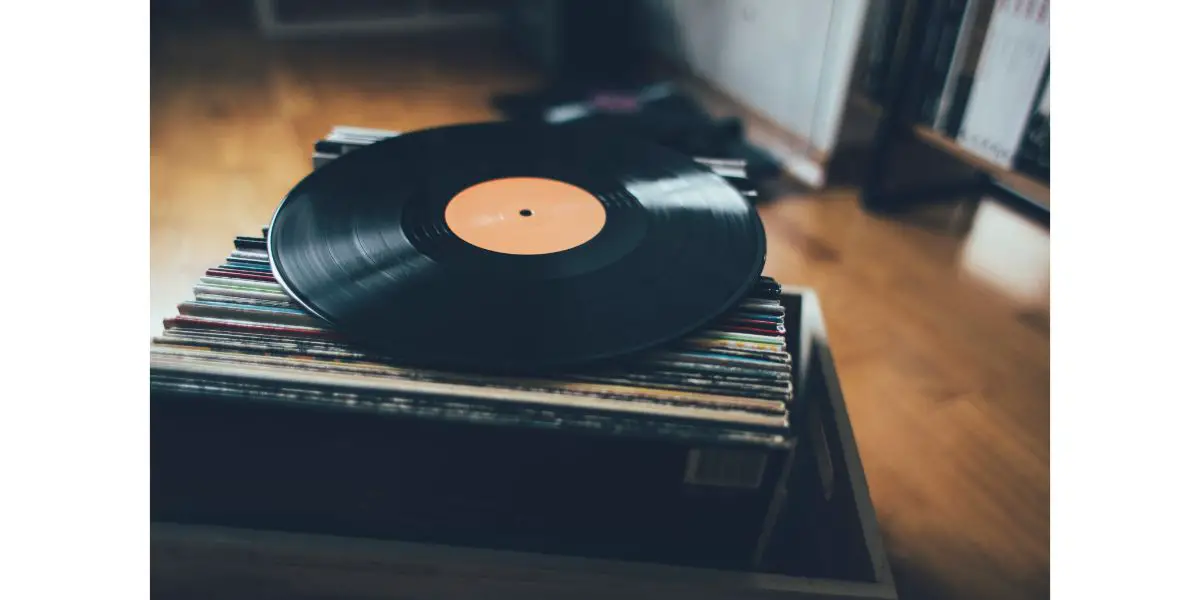 AdobeStock_331497902 Close up of vinyl record on stack of records collection