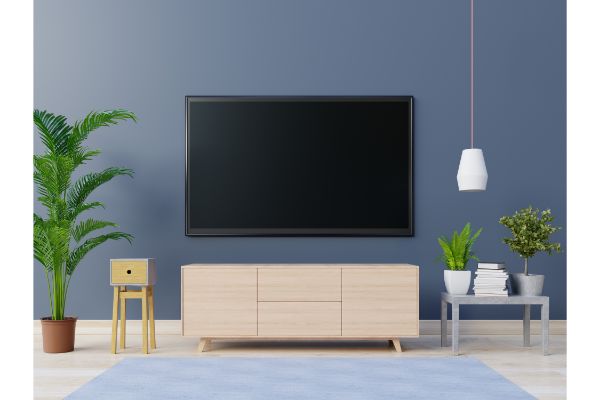 AdobeStock_351463311 Television Set With Table And Potted Plants Against Wall At Home