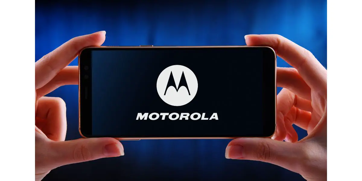 AdobeStock_354023209_Editorial_Use_Only Hands holding smartphone displaying logo of Motorola
