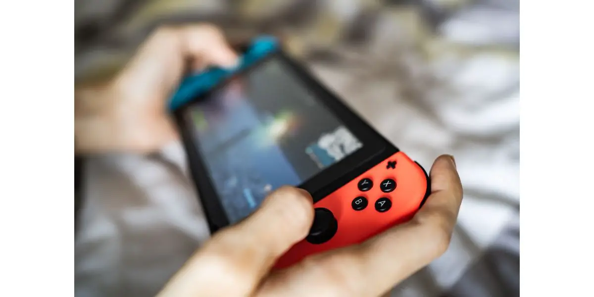 AdobeStock_372144528_Editorial_Use_Only Gamer playing Nintendo Switch, a video game console developed by Nintendo