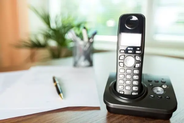 AdobeStock_374859373 Wireless Telephone on a Wooden Desk