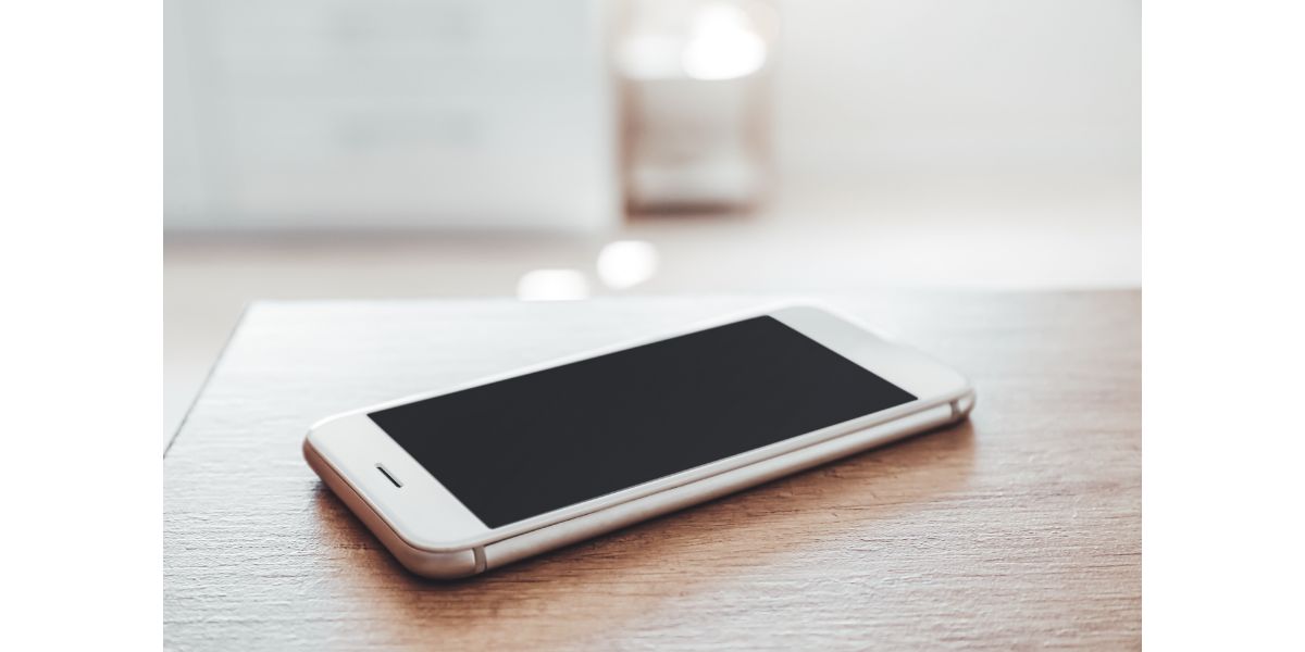 AdobeStock_395687011 Modern mobile phone on table, closeup