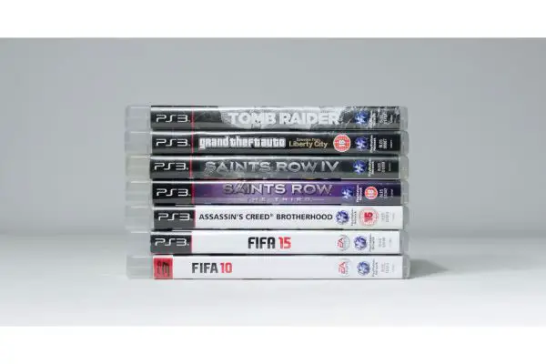 AdobeStock_405199220_Editorial_Use_Only A large pile stack of used playstation 3 video game cases
