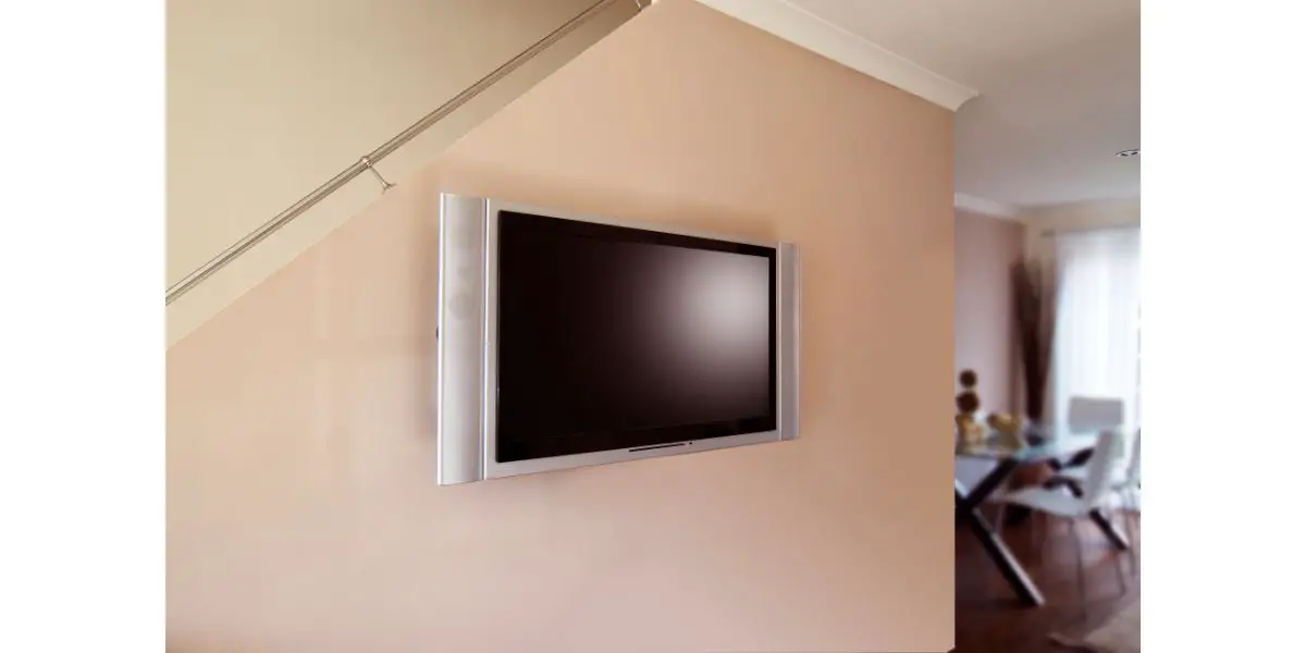 AdobeStock_40609961 plasma tv attached to staircase wall next to dining area
