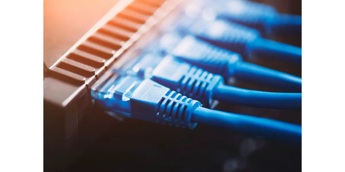 AdobeStock_420328176 Router Wi-Fi close up with a bunch of ethernet cables plugged in. Fast internet modem device.