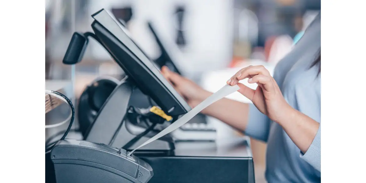 AdobeStock_439134119 Saleswoman printing invoice or receipt for a customer in the shopping center, POS system