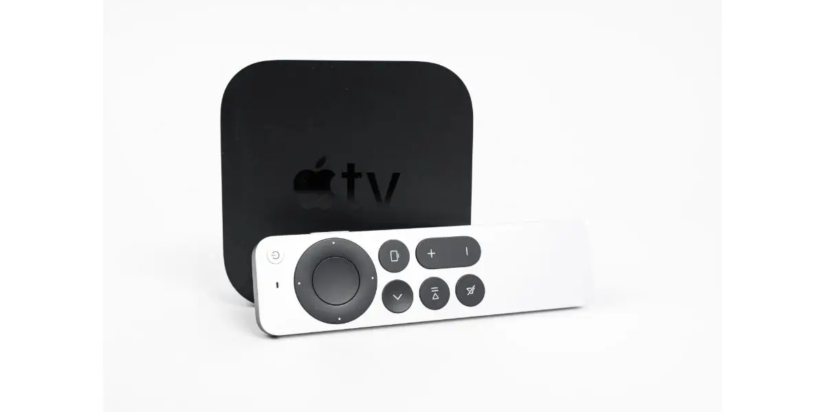 AdobeStock_439204784_Editorial_Use_Only new unpacked Apple TV 4K console and Siri Remote control with a touch-enabled clickpad laying nearby on a white background, front view,