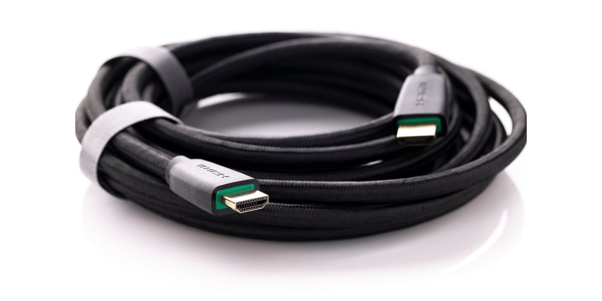 AdobeStock_456555651 coiled up and neatly tied High Definition Multimedia Interface, black HDMI male to male connector cable with braid on white background