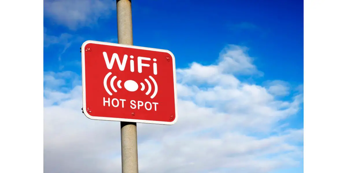 AdobeStock_45732242 WiFi hotspot sign on red sign in the sky