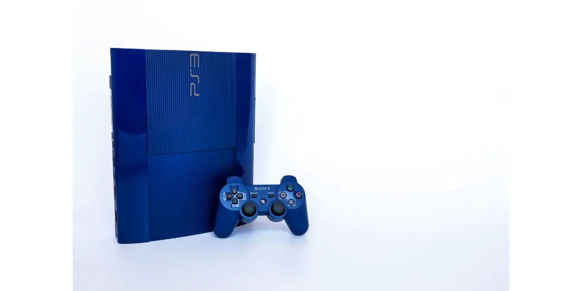 AdobeStock_461870600_Editorial_Use_Only Azurite Blue model of Playstation 3 home video game console with wireless PS3 DualShock controller.