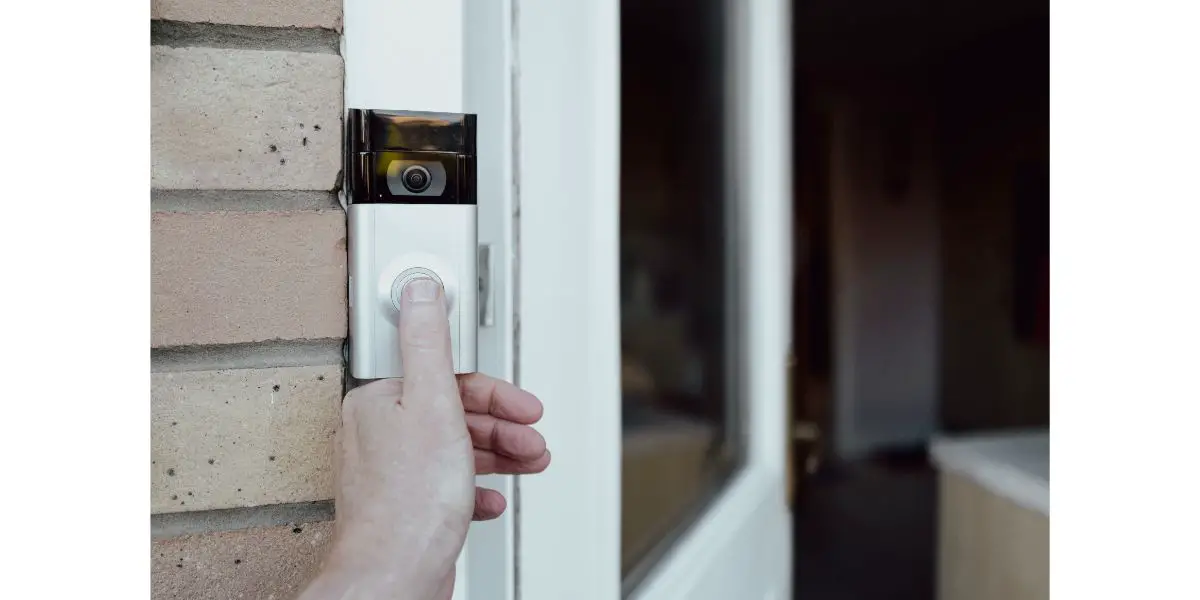AdobeStock_469337204 Shallow focus of a homeowner seen testing a newly installed WiFi smart doorbell