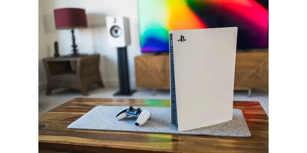 AdobeStock_491408842_Editorial_Use_Only PlayStation 5 video games console and PS5 controller by living room tv