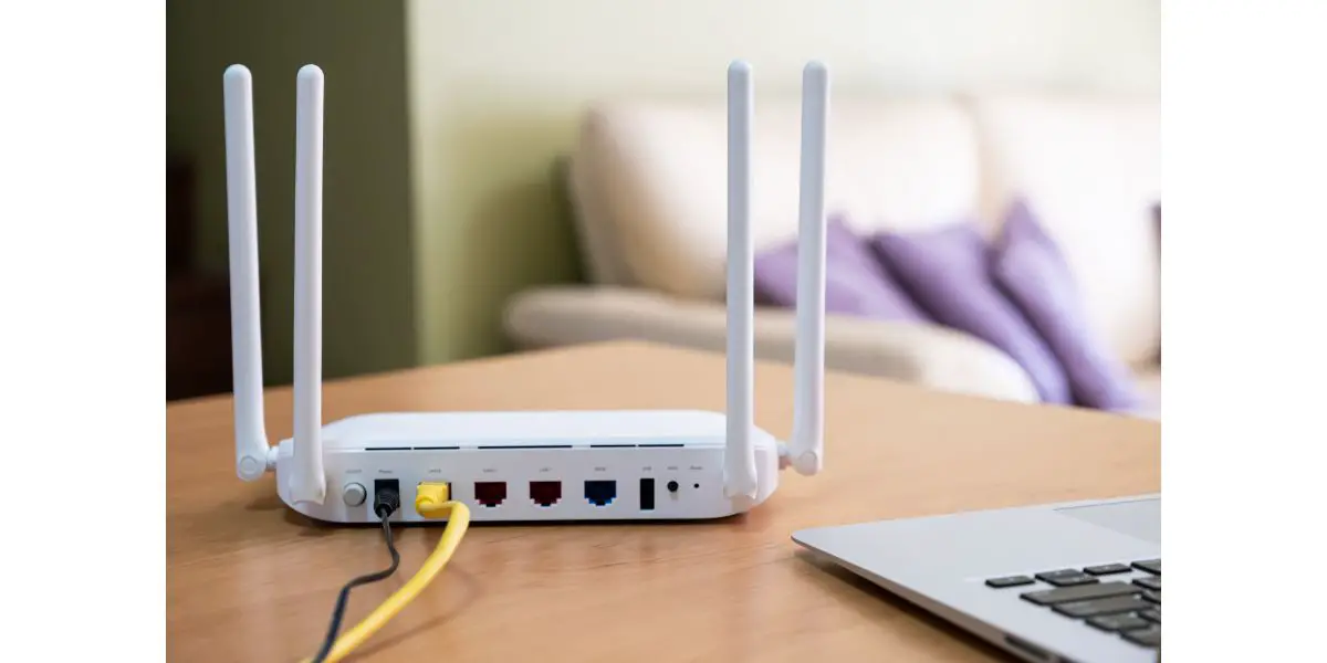 AdobeStock_492189994 Selective focus at router. Internet router on working table with living room no people at the background
