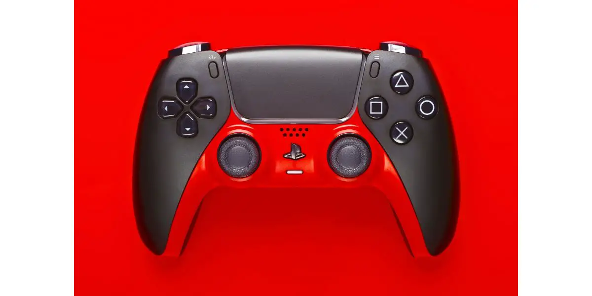 AdobeStock_510903275_Editorial_Use_Only Custom Modded Playstation 5 Gaming Controller on red background.