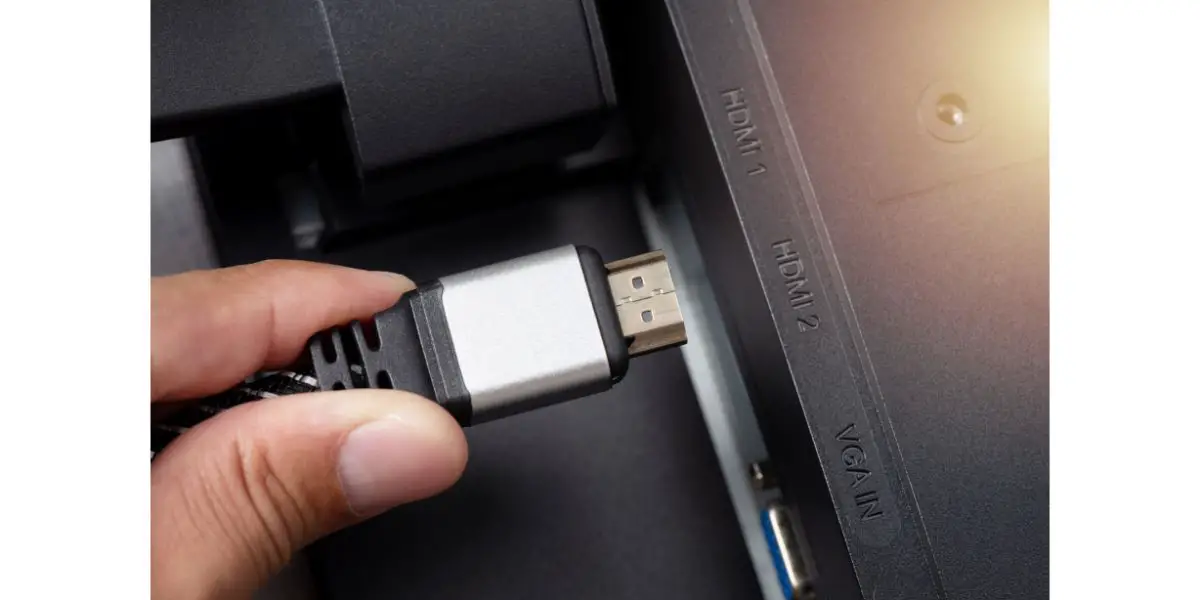 AdobeStock_532077617 plugging a hdmi cable into a hdmi port 2 on a monitor