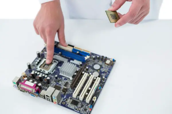 Computer engineer repairing motherboard