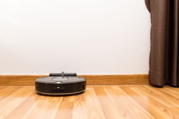 Depositphotos_100620620_S Robotic vacuum cleaner on wood parquet floor