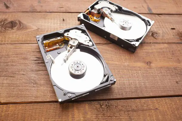 Depositphotos_112436630_S 2 opened up hard drives wood background