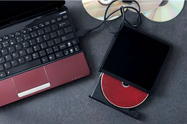 Depositphotos_134780438_S Laptop with connected portable optical drive