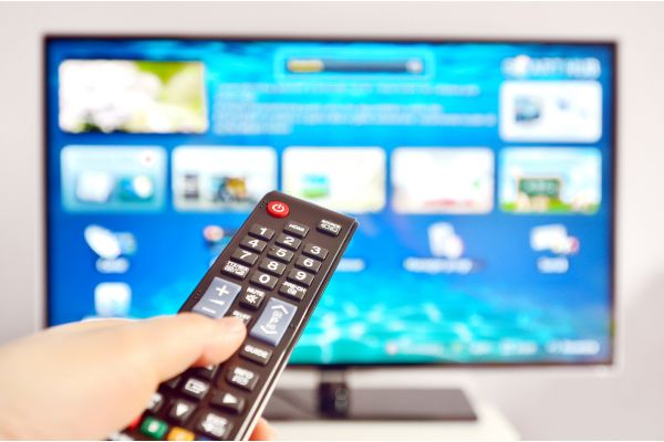 Depositphotos_16342501_S Smart tv and hand pressing remote control