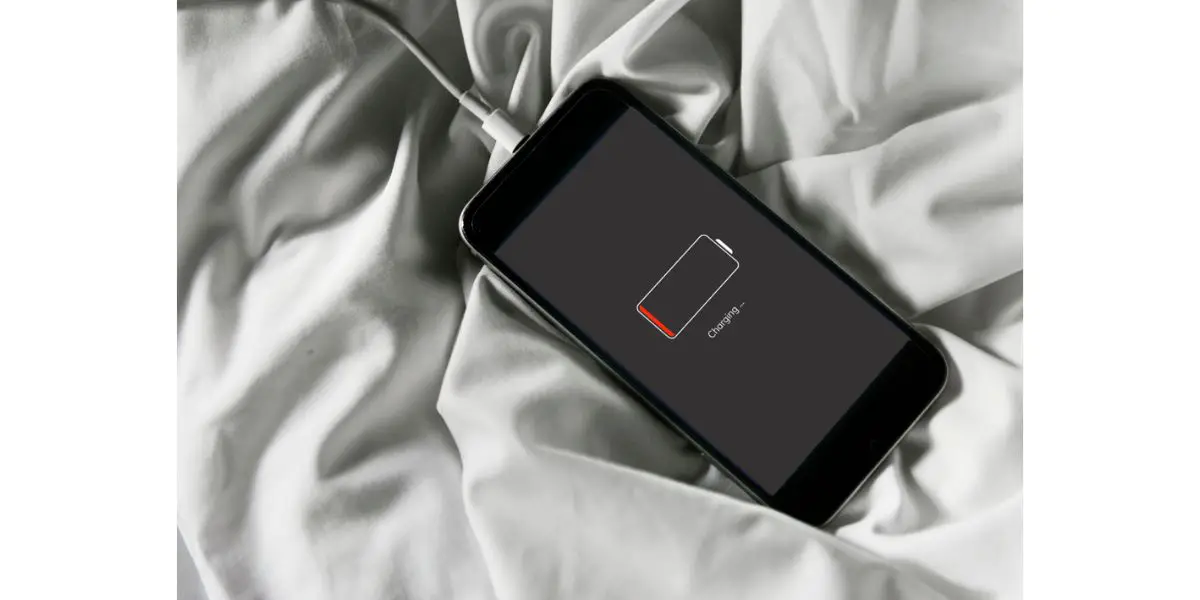 Depositphotos_172157700_S mobile phone charging on bed sheets