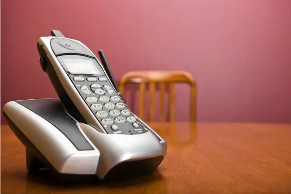 Depositphotos_18879525_S Cordless phone on a table with chair