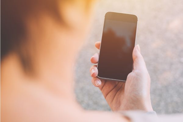 Depositphotos_194051874_S Close up of female hands using smartphone outside