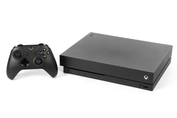 Depositphotos_194135832_S A studio shot of a Microsoft XBOX One X with controller on a white background