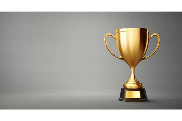 Depositphotos_202832090_S Golden winner cup on grey background