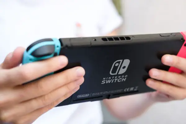 Depositphotos_204477828_S playing game on Nintendo Switch console close up