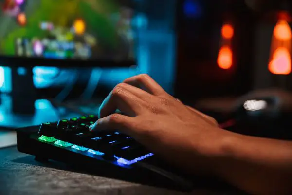 Depositphotos_211746482_S Hands of professional gamer man playing video games